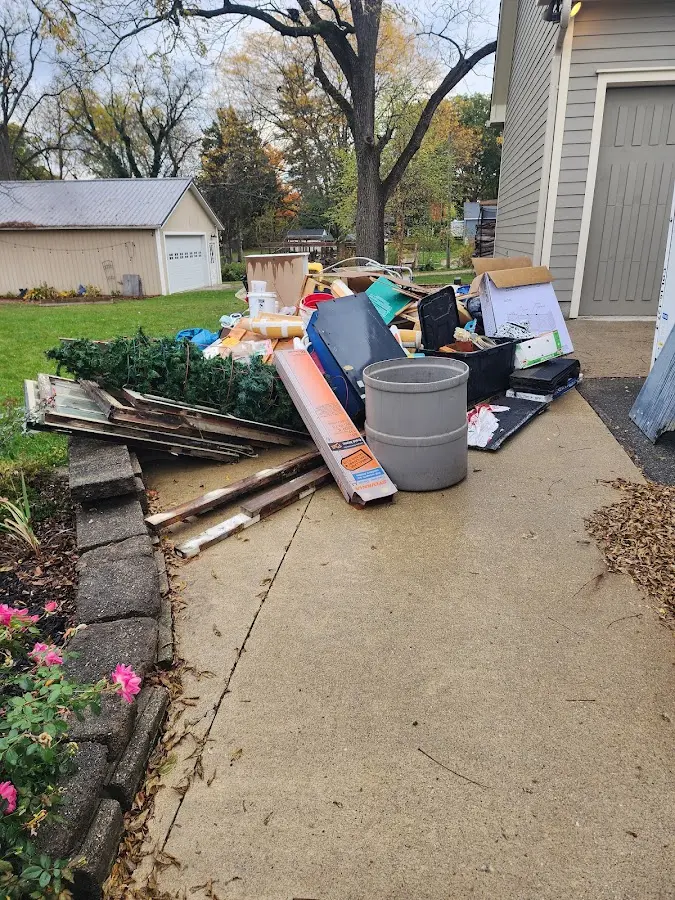 Dumpster being loaded with debris for 3 Yard Dumpster Rental in Minot AFB